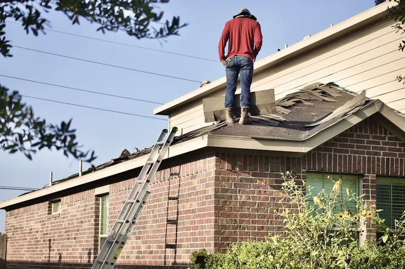 Professional roofer working on a residential roof in Meadow Hills